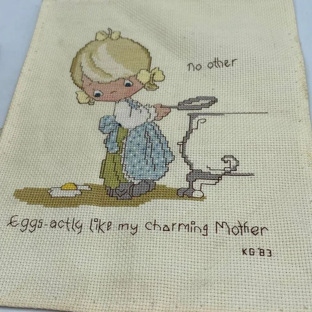 Vintage cross stitched needle point art featuring a nostalgic style scene.
